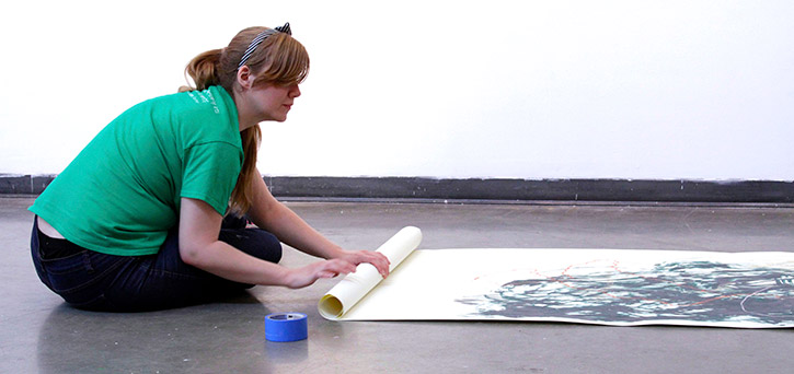 A student in the School of Art working in a light-filled studio space.