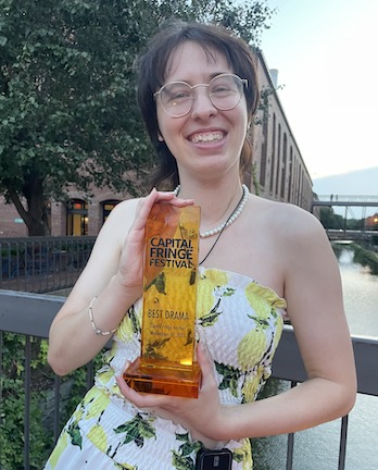 Bella the playwright with award