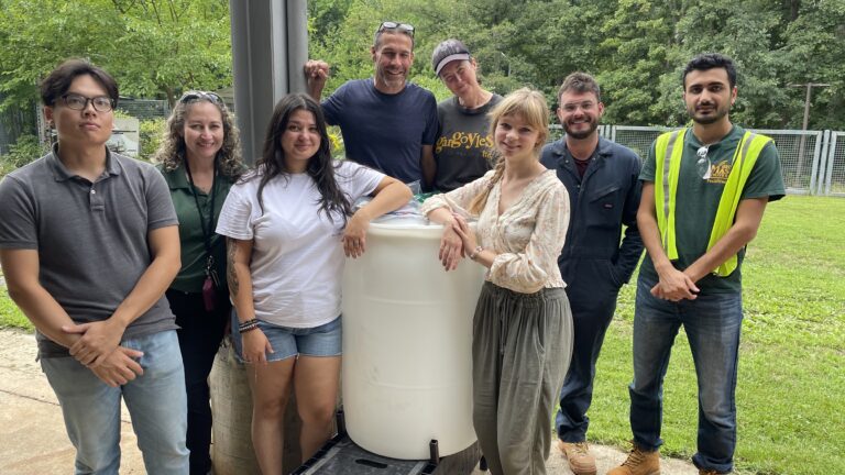 School of Art and Facilities Team members with the new rain barrel in the School of Art Sculpture Yard