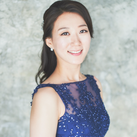 Dr. Hakyong Kelly Park wearing a blue dress.