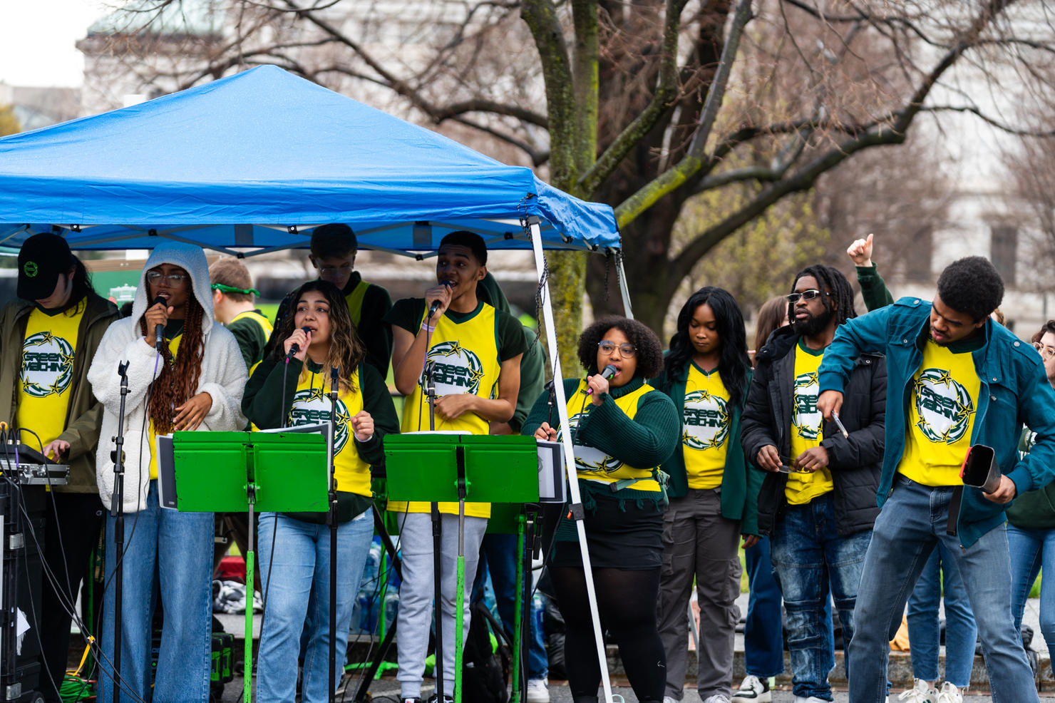 Performers with the Green Machine Ensembles sing and dance while gathered underneath a tent at the 2024 White House Easter Egg Roll. Photo by Joshua Cruse & Nathaniel Henry / Green Machine Ensembles
