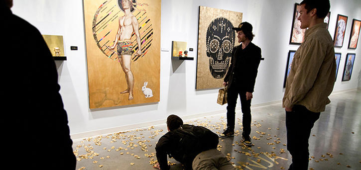 Students study artwork at the Fine Arts Gallery