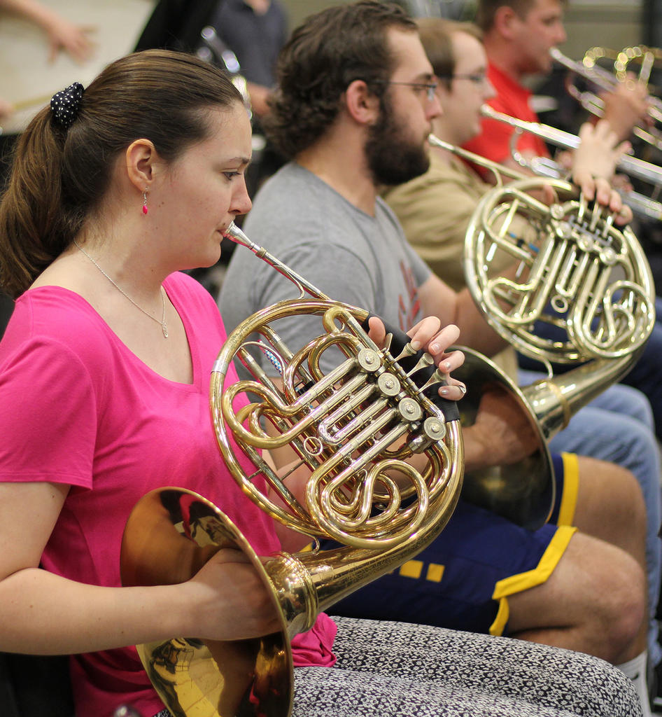 French horns being played by female and male student at Dewberry School of Music