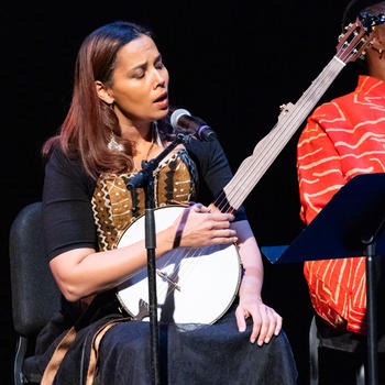 Silkroad Ensemble Artistic Director Rhiannon Giddens joins the group in song.