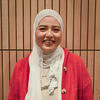 Ree is wearing a red sweater with white hijab 